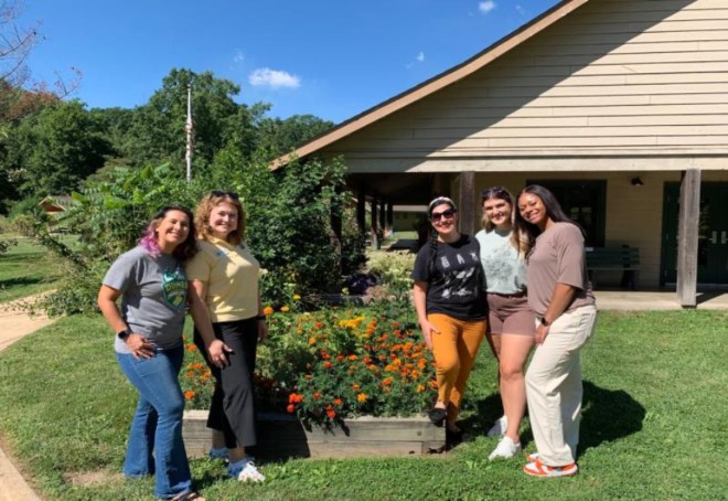 Four Women pose together in front of House After Pest Service in Northfield, IL<br />
