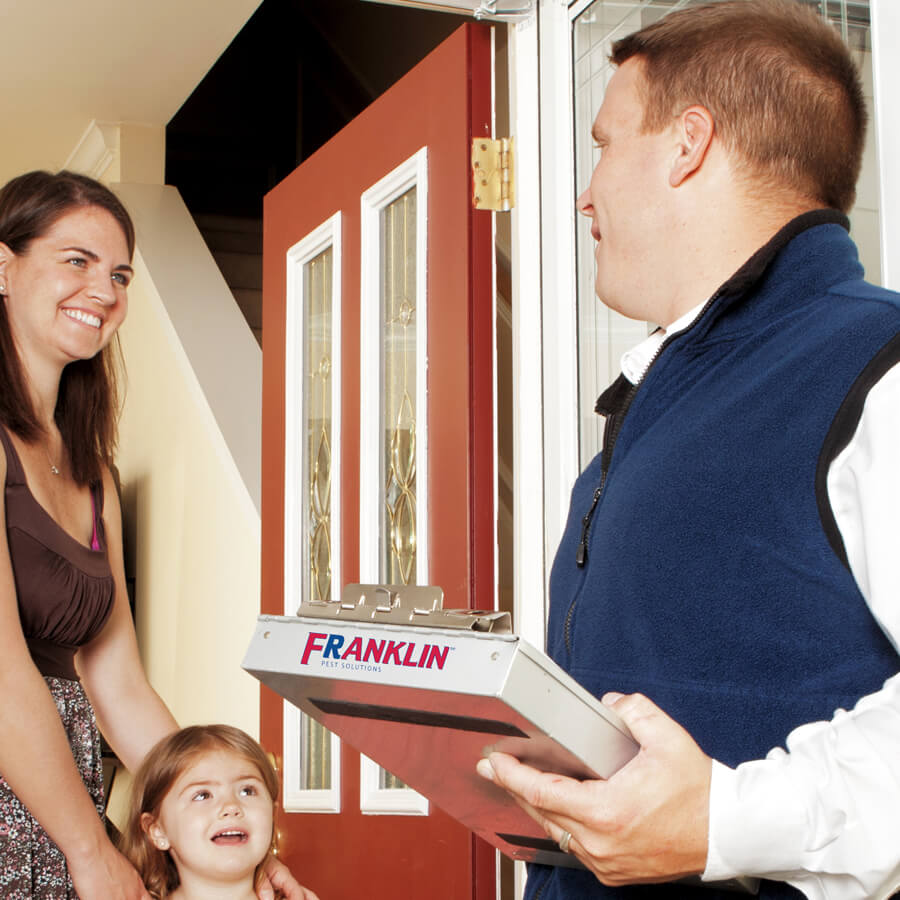 A Pest Technician Planning a Pest Control Service with a Customer in Northfield, IL