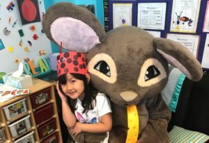 Franklin Pest Control Rosie mascot with student in classroom